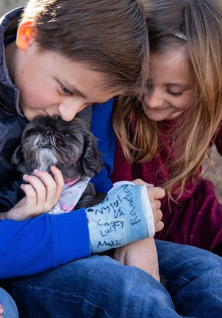 Dog Kids children petting their senior dog